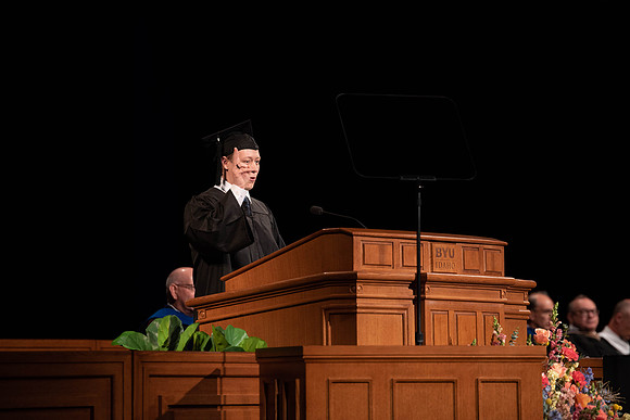 Students partipate in walking to graduate from the College of Business and Communication.