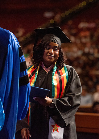 Students partipate in walking to graduate from the College of Business and Communication.