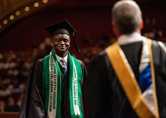 Students partipate in walking to graduate from the College of Business and Communication.