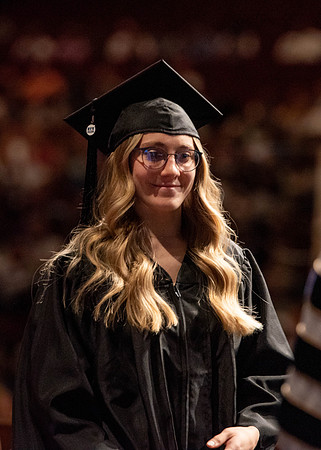 Students partipate in walking to graduate from the College of Business and Communication.