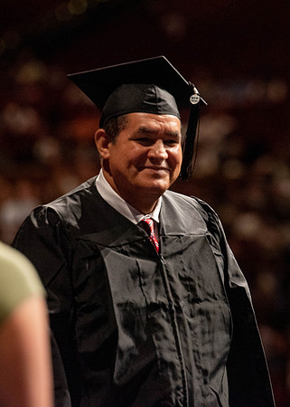 Students partipate in walking to graduate from the College of Business and Communication.