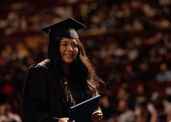 Students partipate in walking to graduate from the College of Business and Communication.