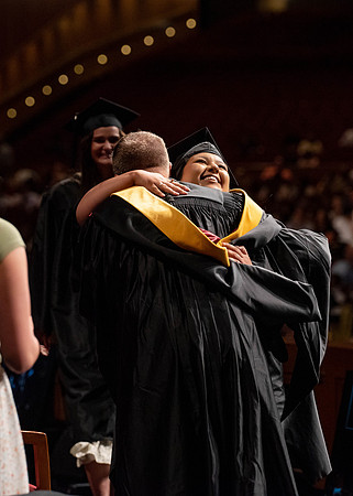 Students partipate in walking to graduate from the College of Business and Communication.