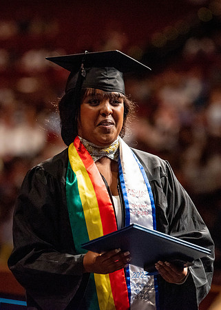 Students partipate in walking to graduate from the College of Business and Communication.