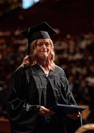Students partipate in walking to graduate from the College of Business and Communication.