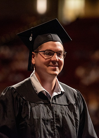 Students partipate in walking to graduate from the College of Business and Communication.