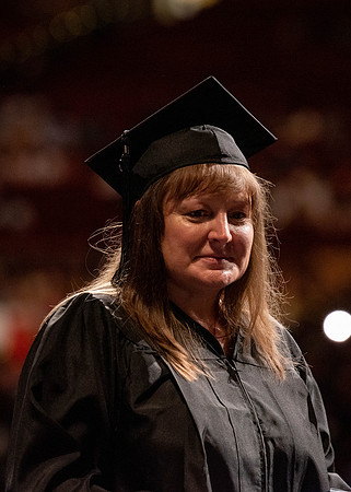 Students partipate in walking to graduate from the College of Business and Communication.