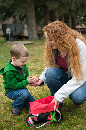 Karen Peacock, gathering chicken eggs with her grandson.