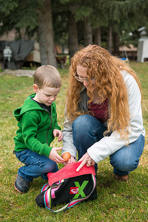 Karen Peacock, gathering chicken eggs with her grandson.