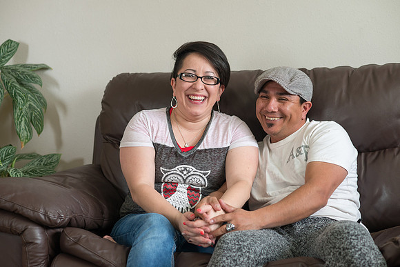 Pathway student, Marcela Avila in her home with her husband.