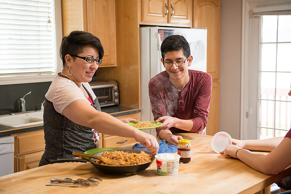 Pathway student, Marcela Avila in her home with her husband and three kids.