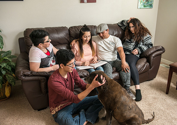 Pathway student, Marcela Avila in her home with her husband and three kids.