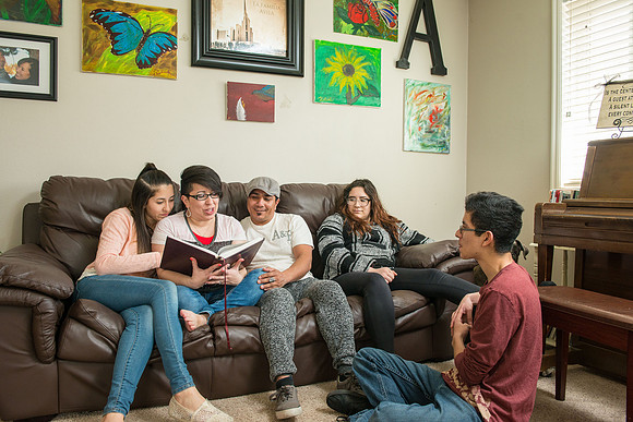 Pathway student, Marcela Avila in her home with her husband and three kids.