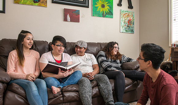 Pathway student, Marcela Avila in her home with her husband and three kids.