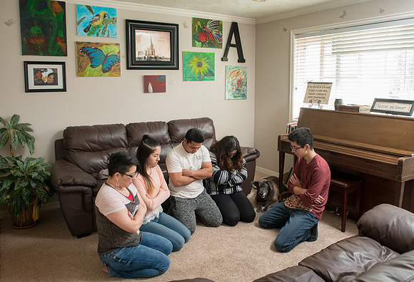 Pathway student, Marcela Avila in her home with her husband and three kids.