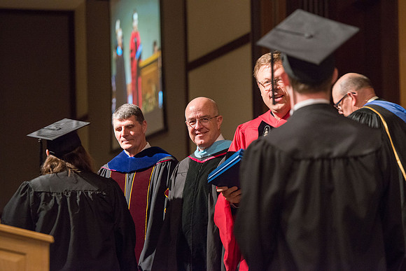 President Gilbert and Elder L. Whitney Clayton at graduation. April 2017