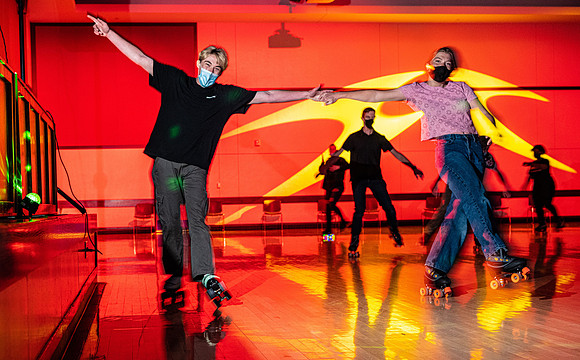 Students enjoy rollerskating a the MC wearing masks.