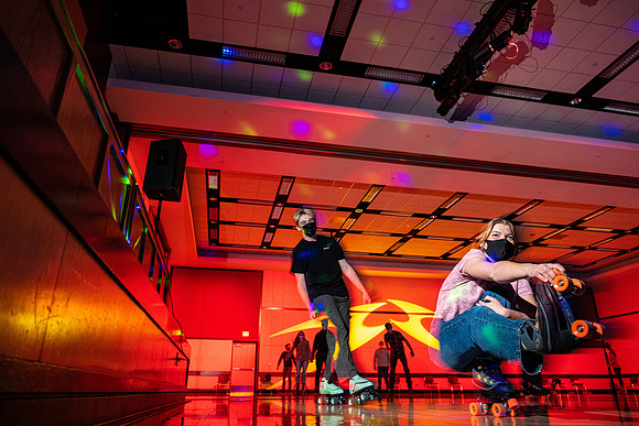 Students enjoy rollerskating a the MC wearing masks.