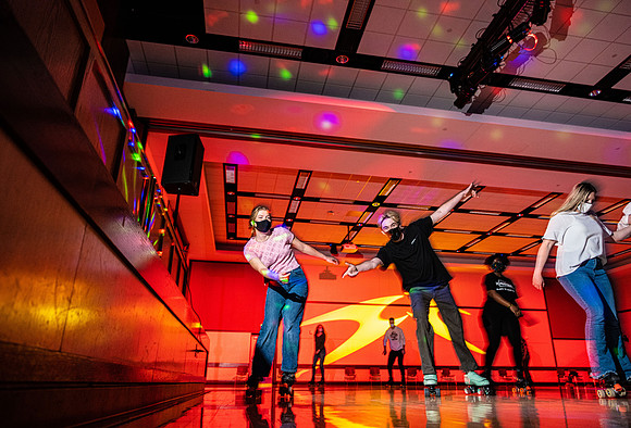 Students enjoy rollerskating a the MC wearing masks.