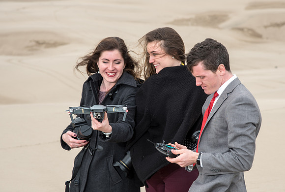 University Relations Photographers Ryan Chase, Courtney Thomas and Emily Gottfredson. Field trip to the sand dunes for a change of scenery and to get a group photo.