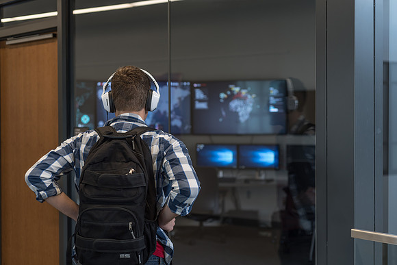 A student stands outside the Cyber Security Lab in the Science and Technology Center.
