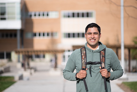 Damon Ballesteros stands in front of the McKay Library. 2017