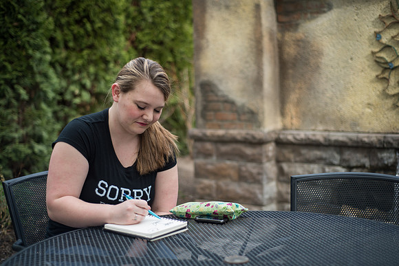 A student works on sketches in the gardens. 2017