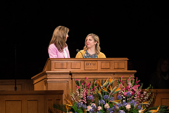 Sister Kelly Eyring speaks with a student about "saying hello to everyone on campus."