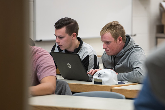 Students get back to school and begin their studies in the Science and Technology Building.