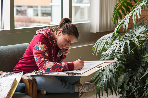 Katie McWhite works on an art project in the McKay Library. 2017