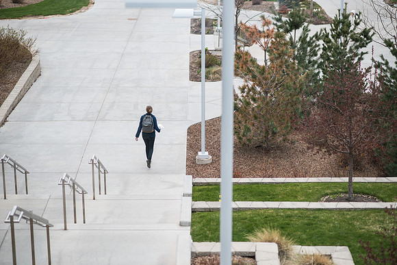 A student walks down the sidewalk on the BYU-I campus. 2017