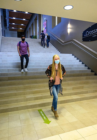 Student volunteers show the way to stay safe during this COVID 19 pandemic by social distancing, following pathway arrows and proper wearing of masks .