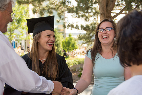 Faculty, family and graduates around campus after the commencement ceremony.