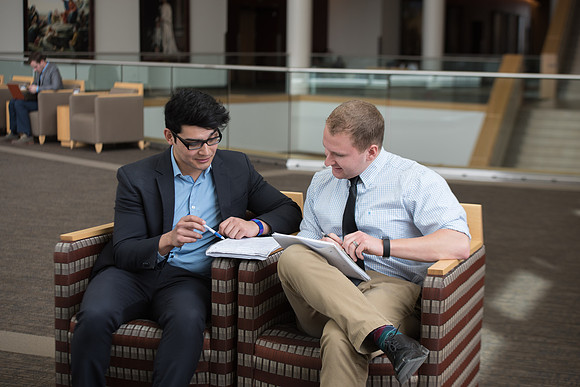 Students discuss class projects in the BYU-Idaho Center.