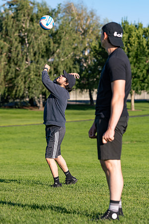 Students gather to play volleyball.
