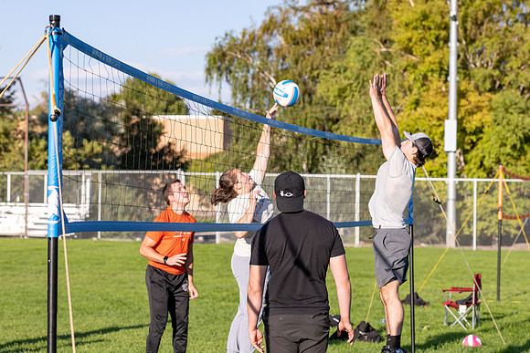 Students gather to play volleyball.