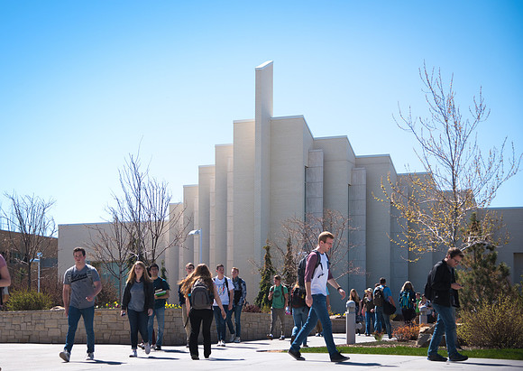 Students walk from class to class in front of the Taylor Building.