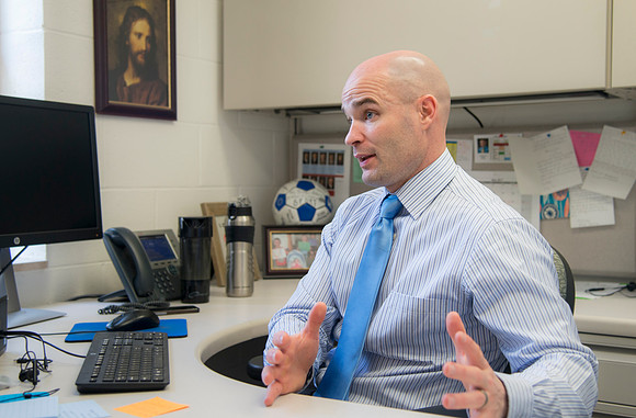 Joseph Anderson working with a student in an Anatomy and Physiology Lab.