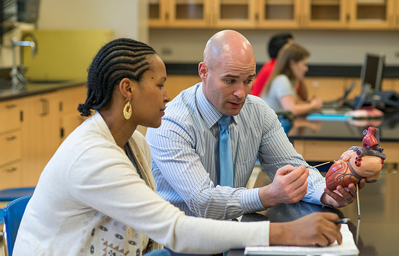 Joseph Anderson working with a student in an Anatomy and Physiology Lab.