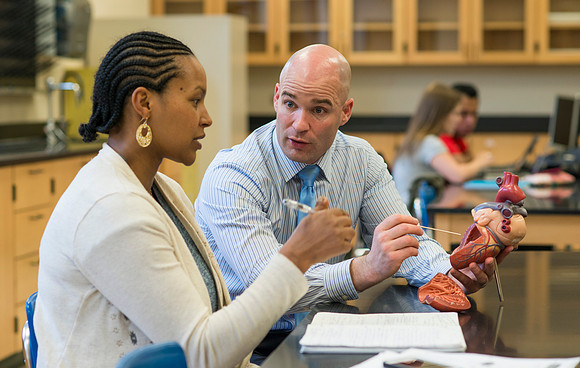 Joseph Anderson working with a student in an Anatomy and Physiology Lab.