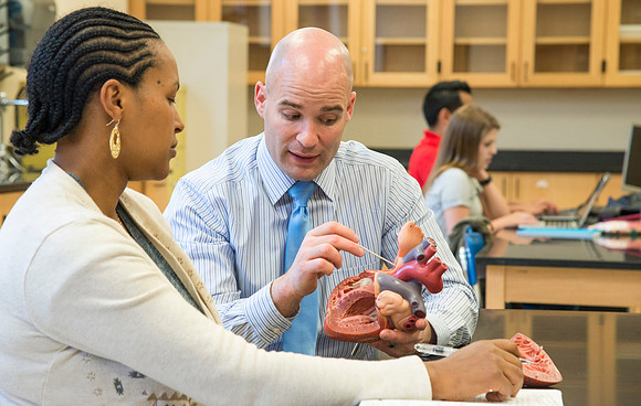Joseph Anderson working with a student in an Anatomy and Physiology Lab.