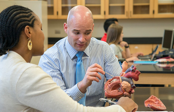 Joseph Anderson working with a student in an Anatomy and Physiology Lab.