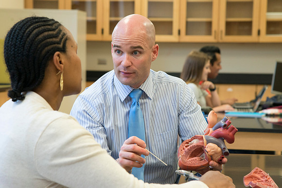 Joseph Anderson working with a student in an Anatomy and Physiology Lab.