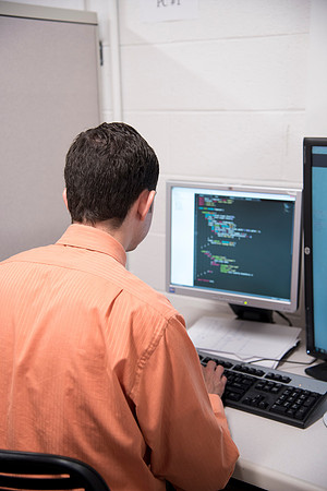 Employees work on developing a better curriculum for online students.