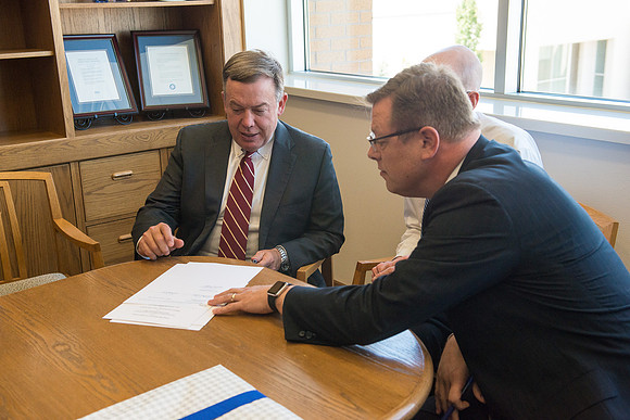 President Michael Crow of Arizona State University visits with President Eyring and Gilbert.