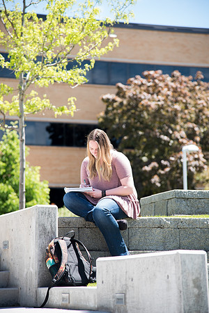 Students enjoy the warm weather in the Ampitheatre.