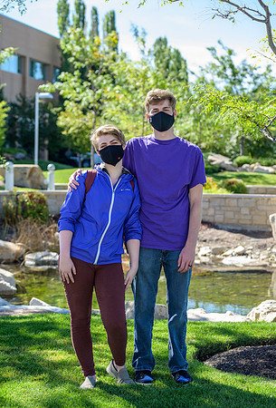 Student volunteers show the way to stay safe during this COVID 19 pandemic by social distancing, following pathway arrows and proper wearing of masks .