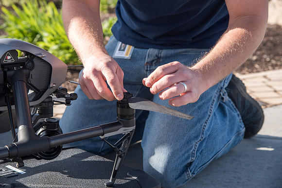 Patrick Kelly preps the drone for aerials of BYU-Idaho campus.