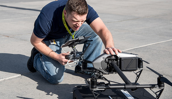 Patrick Kelly preps the drone for aerials of BYU-Idaho campus.