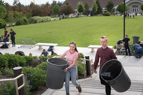 Students gather together to plant flowers on the temple grounds.